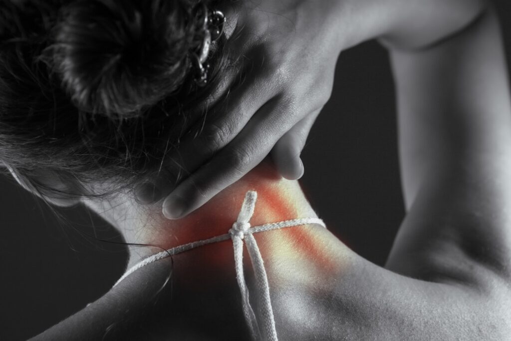 Acute pain in the back of a woman. Pain in the back and neck.